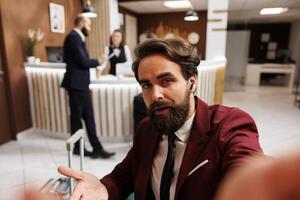 POV of employee calling manager on videoconference online to share international meeting results, hotel lounge area. White collar worker travelling on business trip to forge partnership. photo