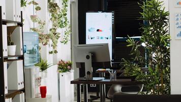Startup company open space with work desks and tools used for small business executive tasks in sales department. Empty company coworking space, boardroom decorations and supplies. photo
