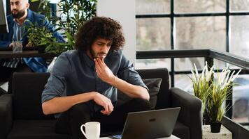 Analyst looks for inspiration to create software program, AI developer thinking about investment in coworking space. Creative businessman reviewing analytics data to work on profit. photo