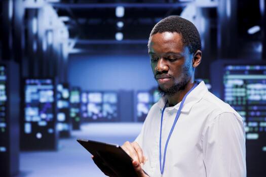 IT specialist in server farm ensuring valuable data remains shielded from potential threats, safeguarding against unauthorized access and vulnerabilities, securing system from virus attacks photo