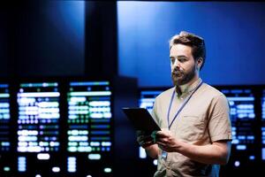 Admin walking in data center supporting AI through powerful computing operations, hosting specialized storage servers. Engineer ensuring high tech facility internal hardware functions properly photo