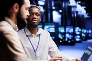 Teamworking IT developers dealing with server hub system failures. Programmers brainstorming ideas on how to best minimize high tech data center downtime and prevent crashes photo