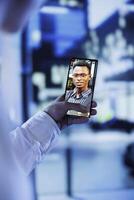 Woman in online videocall with husband while walking around city streets at night, close up. Citizen using phone for remote connection with spouse, showing him surroundings in urban center photo