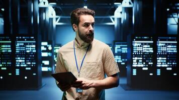 Engineer walking through data center providing computing resources needed for artificial intelligence to process massive datasets for training. Server room storing data used for machine learning photo