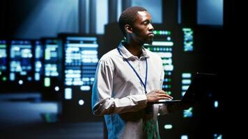 African american precise supervisor monitoring server clusters providing vast computing resources and storage, enabling artificial intelligence to process massive datasets for training and inference photo