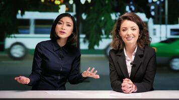 Journalists team opening talk show at night in studio, presenting breaking news or latest scandals in daily newscast live on tv network. Media presenters addressing topics in entertainment panel. photo