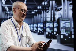 Knowledgeable electrician in data center providing dedicated VPN servers able to deliver encrypted sensitive data, reinforced privacy, online anonymity and secure internet connections to users photo