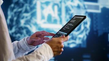 IT developer writing artificial intelligence script code in startup workspace on tablet terminal. Experienced programmer doing maintenance work in high tech facility updating AI systems photo