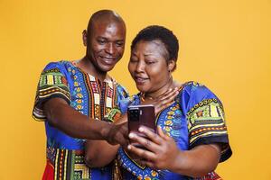 Smiling wife and husband family couple enjoying smartphone app together. Man and woman pair with cheerful expression using social media application software on mobile phone photo