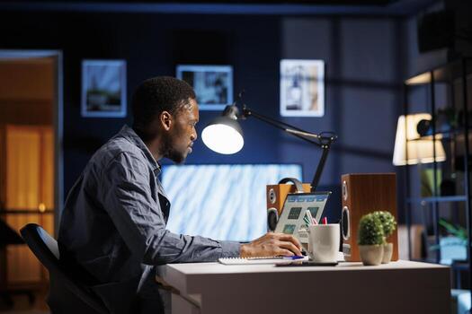 Male financial advisor examines monthly budget and expenses to provide strategic advice on products and services. African american expert analyzing revenue balance, accounting analysis at home. photo