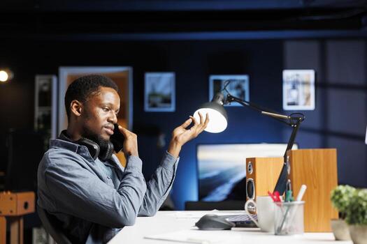 Male investor contacts his accountant at home desk to go over current budget balance, with objective to boost earnings via foreign investments. Man reviewing financial assets with consultant. photo