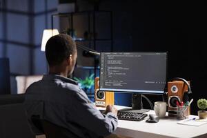 Male developer entering binary data on terminal panel while establishing html code. Software engineer works on troubleshooting with programming language, for protection of databases. photo