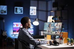 Team member interacting with partners via videoconferencing system, addressing recent business duties and procedures to be handled. Young person on internet videocall, working remotely at home. photo