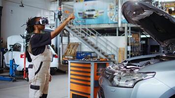 Engineer in auto repair shop using augmented reality technology to visualize car performance parameters. Woman using ar hologram to show customer proposed vehicle upgrades photo