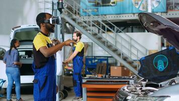 Certified engineer in repair shop using advanced virtual reality technology to visualize car mechanical component in order to fix it. Garage expert wearing vr glasses while mending broken vehicle photo