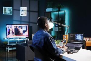 Black woman working on laptop managing code and programming in artificial intelligence and machine learning. African american female freelancer using personal computer to ensure cyber security. photo