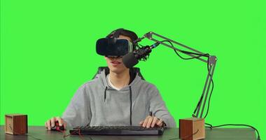 POV of streamer using virtual reality glasses and broadcasting live action gameplay while sitting at desk, playing online competition. Content creator records a arcade stream using vr headset. photo