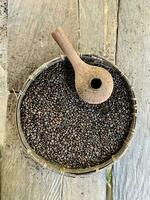 Texture of coffee beans, coffee beans slices of green leaves. beautiful light, vigor of coffee beans, among coffee bushes, Roasted coffee beans on old wooden table photo