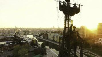 Aerial of the forefront of the monument to Peter the Great, Moscow, Russia. Scene. Fragment of the monument to Emperor Peter the Great on big city and bright sunset background. photo