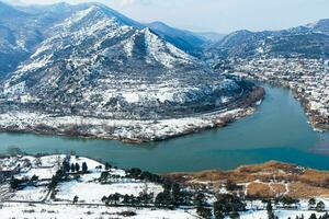 Jvari Monastery is one of the most famous place in Georgia. Top view of with Mtskheta town and the confluence of the Mtkvari and Aragvi rivers. photo