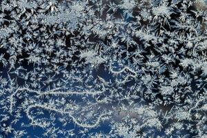 frosty patterns on the window frosty background Ice on a window photo