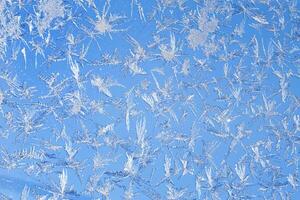 frosty patterns on the window frosty background Ice on a window photo