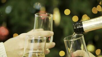 Celebration or party. People holding glasses of champagne making a toast. Clinking glasses of champagne in hands on bright lights background photo