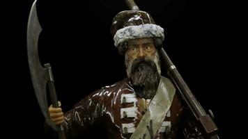 Historical small model of a warrior with an axe. Stock footage. Close up of suit of a man with a gun. photo