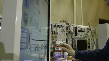 Man works on a touch screen. Young scientist uses a large touch screen to work photo