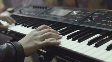 MIDI keyboard synthesizer piano keys. Stock. Woman playing the synthesizer. A music instrument background, music concept photo