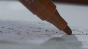 A red marker writes on a sheet of paper. Close-up. Marker Tip. Red marker with shadow photo