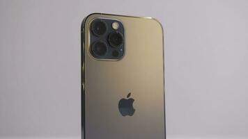 Beijing, China - 11.23.2020. Close up of a new iPhone 12 Pro Max in Pacific blue color. Action. Presentation of a new device with three cameras isolated on white background. photo