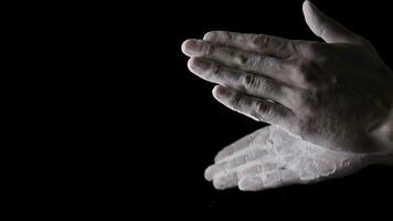 Chef Hands Clapping With Flour In Slow Motion on black background. Frame. Chef Claps Hands Together With Flour, Super Slow Motion photo