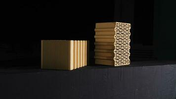 Close-up of two red bricks on black background. Stock footage. Demonstration of two red ceramic blocks with wavy lines for building house on black background photo