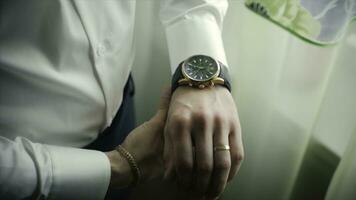 Closeup designer watch on businessman hand. Clip. Hand of businessman with a clock photo