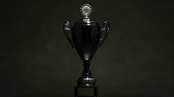 Champion golden trophy placed on wooden table with dark background copy space ready for your design win concept. still life image of trophy shot in the studio. champion golden trophy on wood table photo