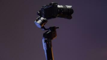 The concept of shooting with gadgets. Action.A large swivel tripod on which a large video camera is attached shoots in different directions on a bright purple background. photo