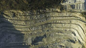 Panoramic view of quarry. Shot. Top view of picturesque quarry located on coastal mountain near village in forest. Concept of mining photo