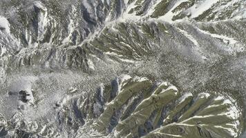 Top of High mountains, covered by snow. Shot. Top view of the snowy hill. Beautiful landscape photo