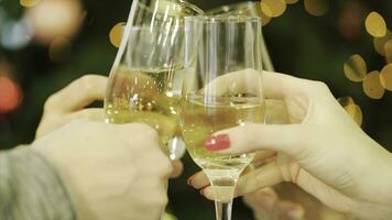 Celebration or party. People holding glasses of champagne making a toast. Clinking glasses of champagne in hands on bright lights background photo