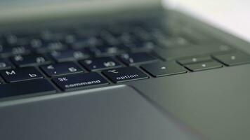 Silver laptop with black keybord details. Action. Close up of a new modern laptop, concept of technological progress and technologies. photo