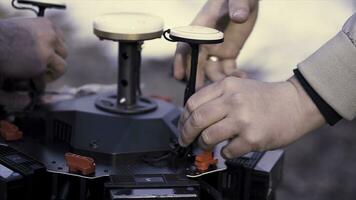 Close up for hands performing assembly of the device for quadcopter filming, modern technologies concept. Clip. Preparation of space orientation system for drone. photo