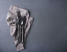 Craft iron tableware in grey background photo