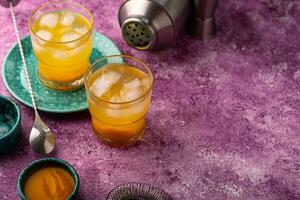 Summer cocktail with mango juice and ice photo