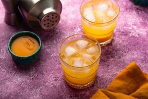 Summer cocktail with mango juice and ice photo