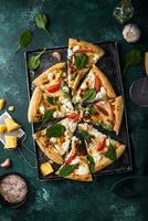 Italian pizza with feta cheese, tomato and basil photo