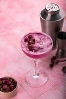 Summer pink cocktail with rose flowers photo