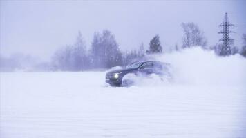 Sports car drives in the snow. The machine demonstrates the ability to drive on a snowy road, drifting and maneuvering photo