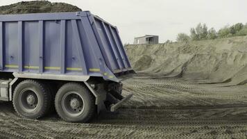 Mining dump truck working at the sand quarry. Scene. Industrial background at the quarry or at the construction site. photo