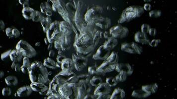 Close up of bubbles of air underwater on a black background. Stock footage. Boiling water macro view. photo